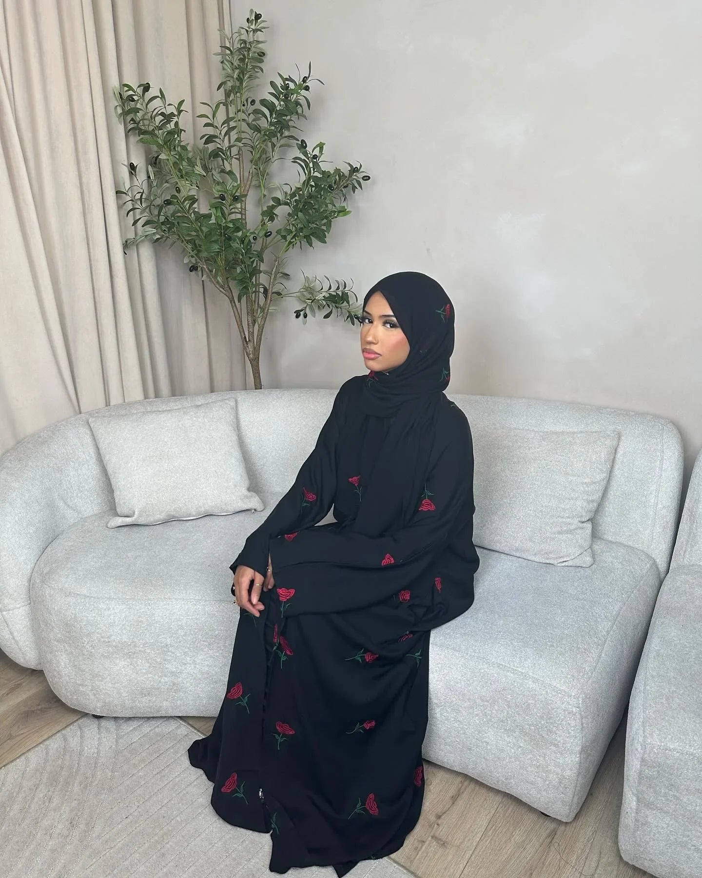 Model wearing The Maison Brodee in black with matching hijab