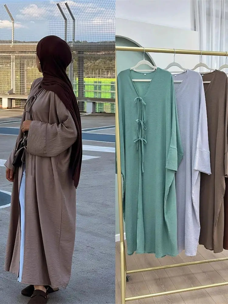 Model wearing The Maison Quietude kimono in dark khaki, walking outdoors