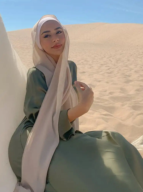 Model wearing a soft beige chiffon hijab, draped over the shoulder