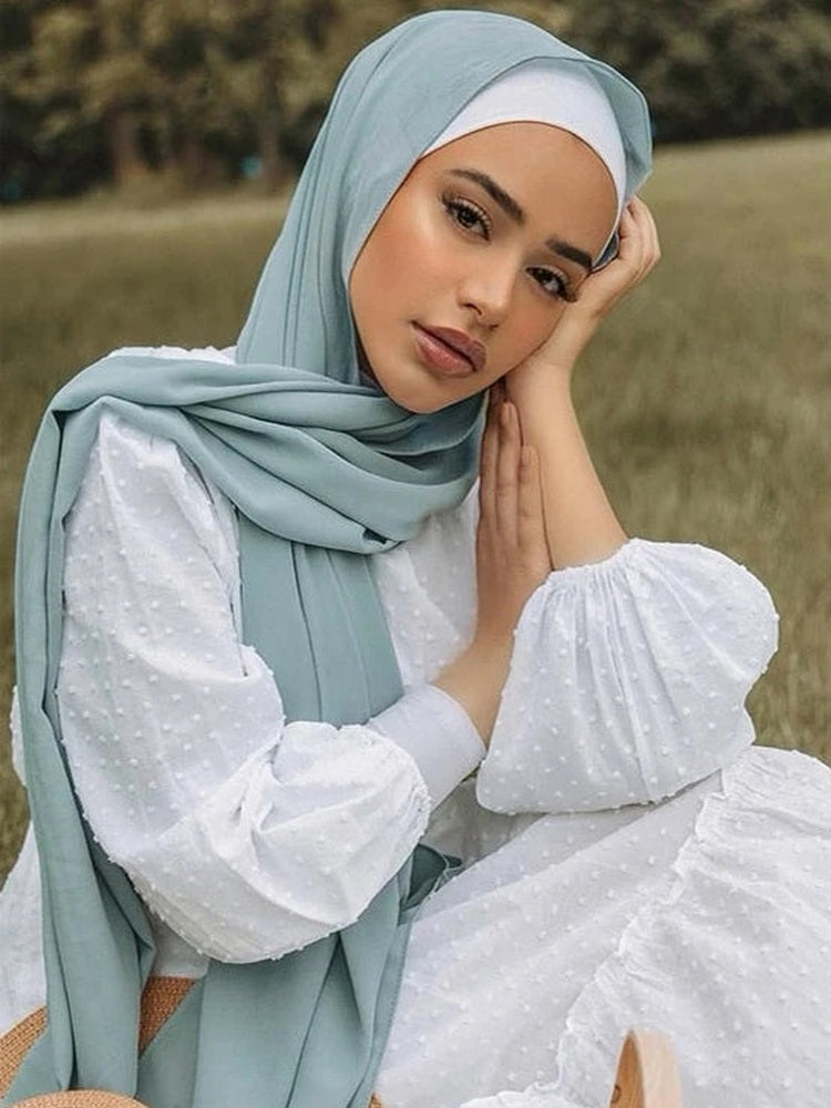 Model wearing a sage chiffon hijab outdoors